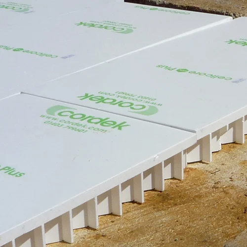 White compressible EPS boards laid out in a foundation for ground heave protection.