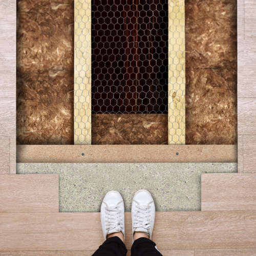 Cutaway view of underfloor insulation batts installed beneath wooden floorboards.