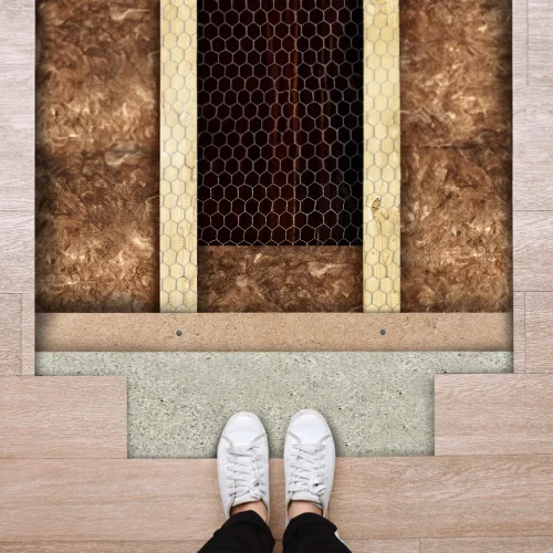 Cutaway view of underfloor insulation batts installed beneath wooden floorboards.
