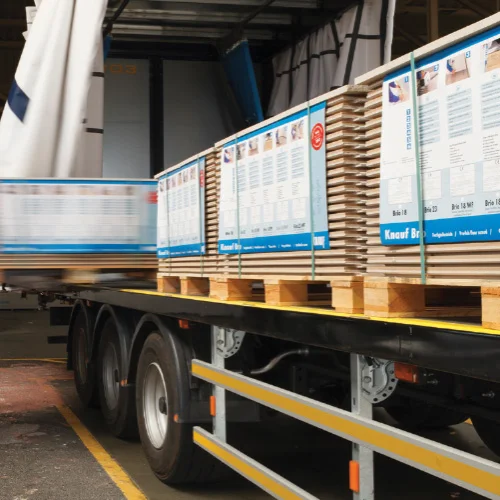Flatbed lorry loaded with pallets of wholesale insulation products.