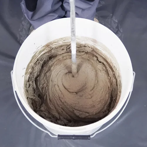 Bucket filled with freshly mixed wet render or adhesive compound.