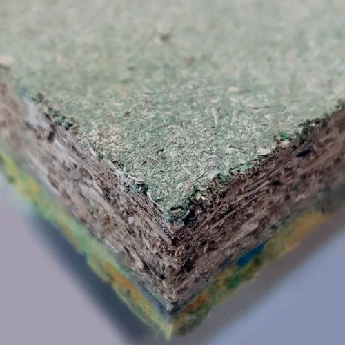 Close-up showing the textured edge of a wood-based composite insulation board.