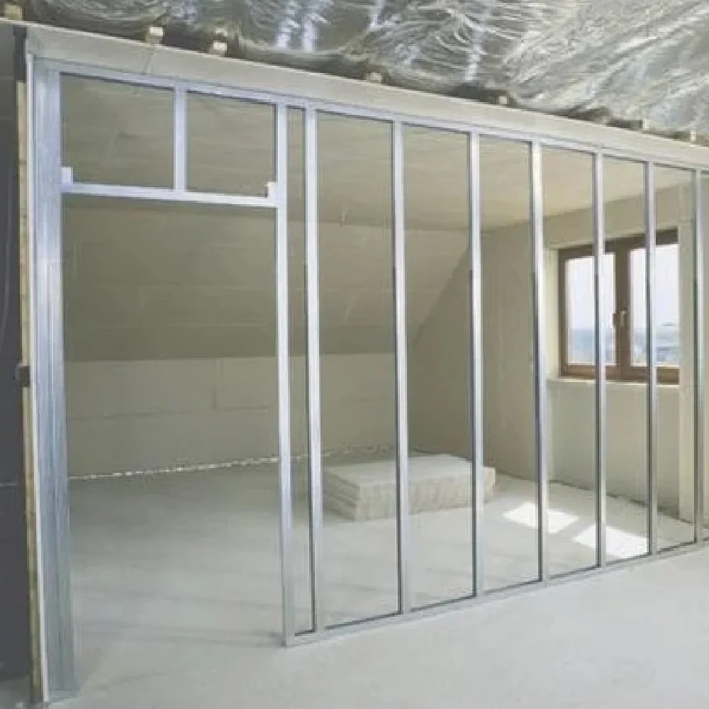 Interior room under construction showing a metal stud framework ready for dry lining boards.