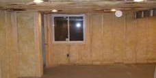 Interior basement room with exposed insulation on walls