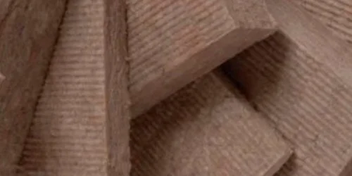 Stack of brown dense acoustic insulation boards