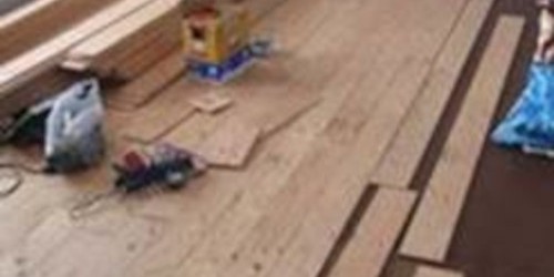 Wooden flooring planks and insulation materials during installation