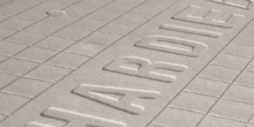 Close-up texture of a cement board embossed with the name "HARDIE"