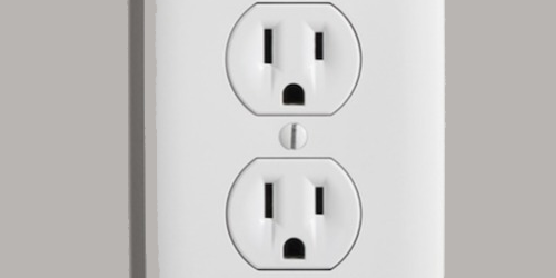 Close-up of a white electrical wall outlet
