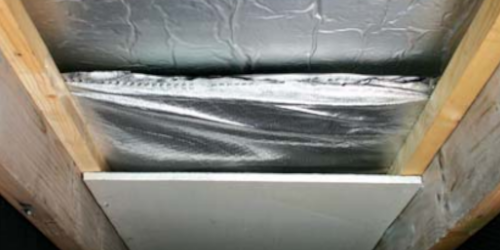 Reflective foil insulation installed between roof rafters in an attic