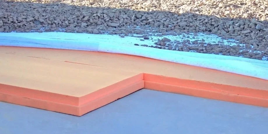 Blue and pink Extruded Polystyrene (XPS) insulation boards installed on a floor sub-base