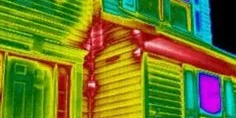 Thermal imaging scan of a house showing heat loss in red and yellow colors