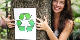 Woman hugging a tree with a white recycling symbol overlay
