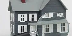 Graphic of a grey house being inspected with a magnifying glass