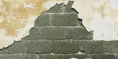 Close-up of a concrete wall showing a damp patch or repair work