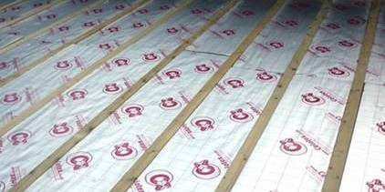Underfloor insulation panels with grid markings installed on a floor