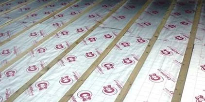 Underfloor insulation panels with grid markings installed on a floor