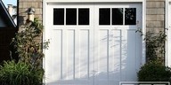 White garage door on a brick building