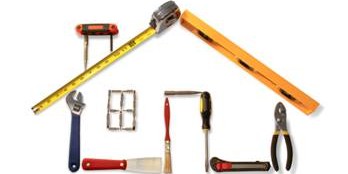 Construction tools arranged to form the shape of a house