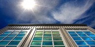 Low angle view of a modern building facade under a bright sun