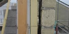 Construction view of a wall cavity being prepared for insulation
