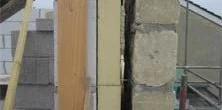 Construction view of a wall cavity being prepared for insulation