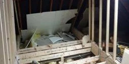 Attic space under renovation with exposed wooden beams